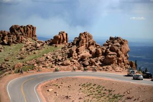 Navigate the twists and turns of the no guardrail Pikes Peak Highway on a bike or in a car. Courtesy VisitCOS.com.