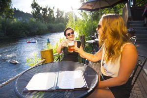Tubing the Yampa River and taking a break for a beverage in Steamboat Springs. Courtesy Colorado Tourism Office.