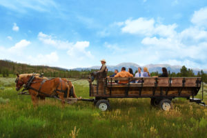 A picturesque wagon ride through a meadow. Courtesy Keystone Resort.